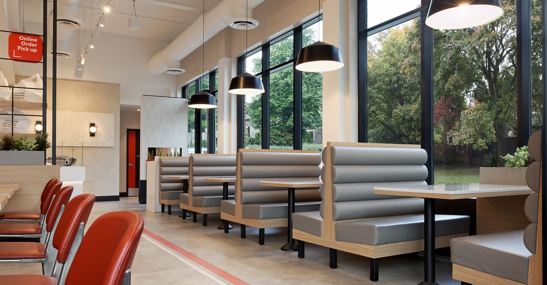 A diner with tables and booths and a lot of windows.