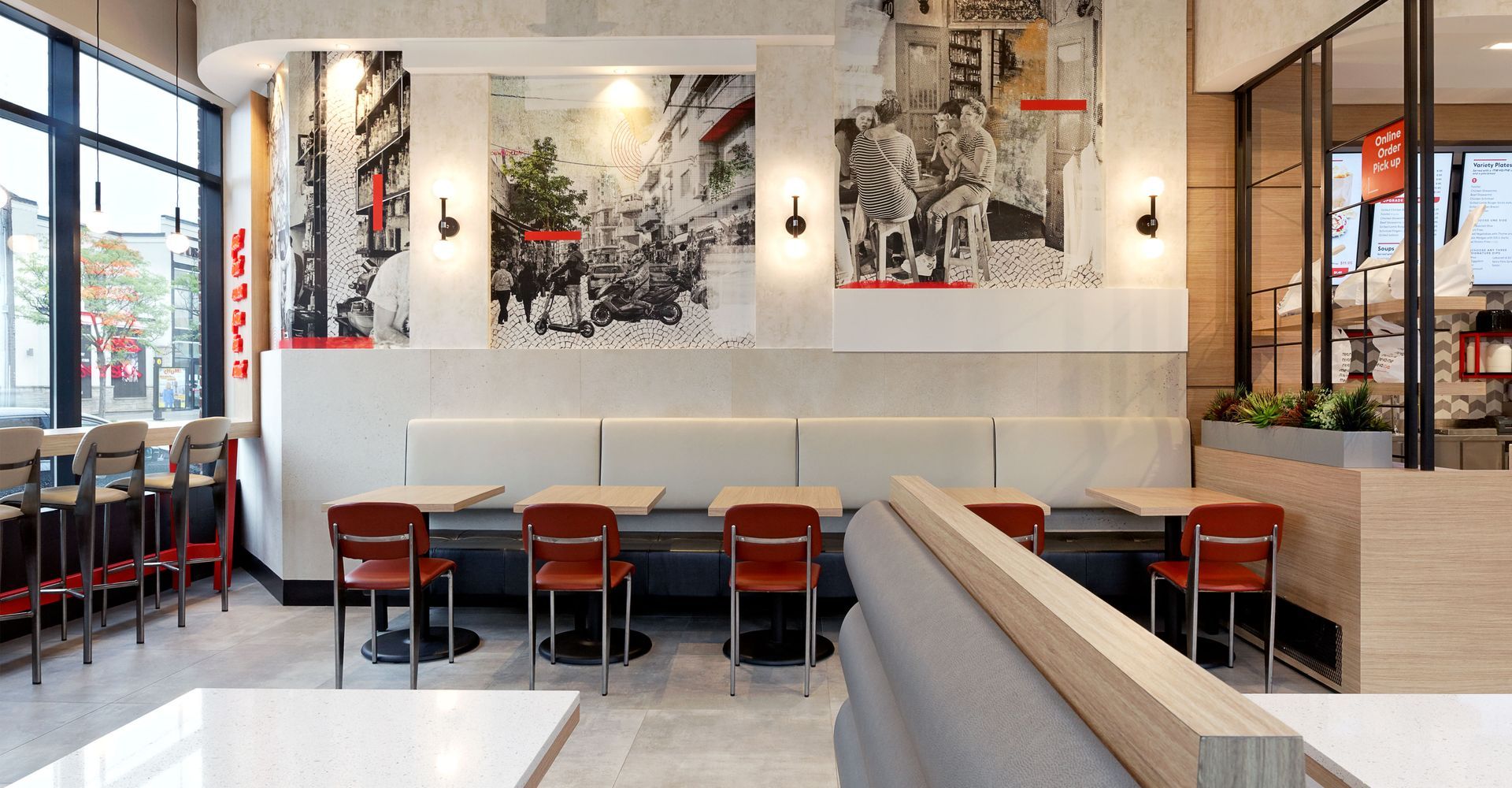A restaurant with tables and chairs and paintings on the walls.