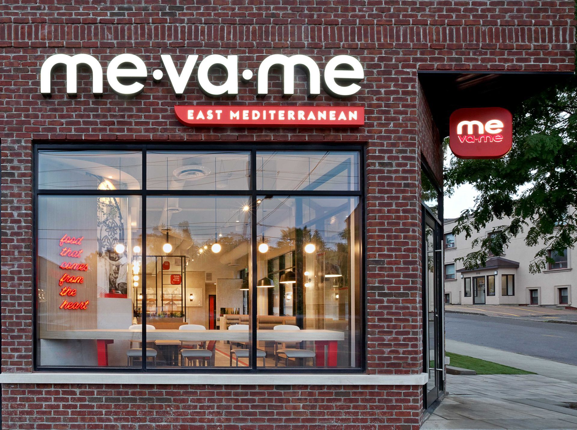 A brick building with a sign that says me-va-me