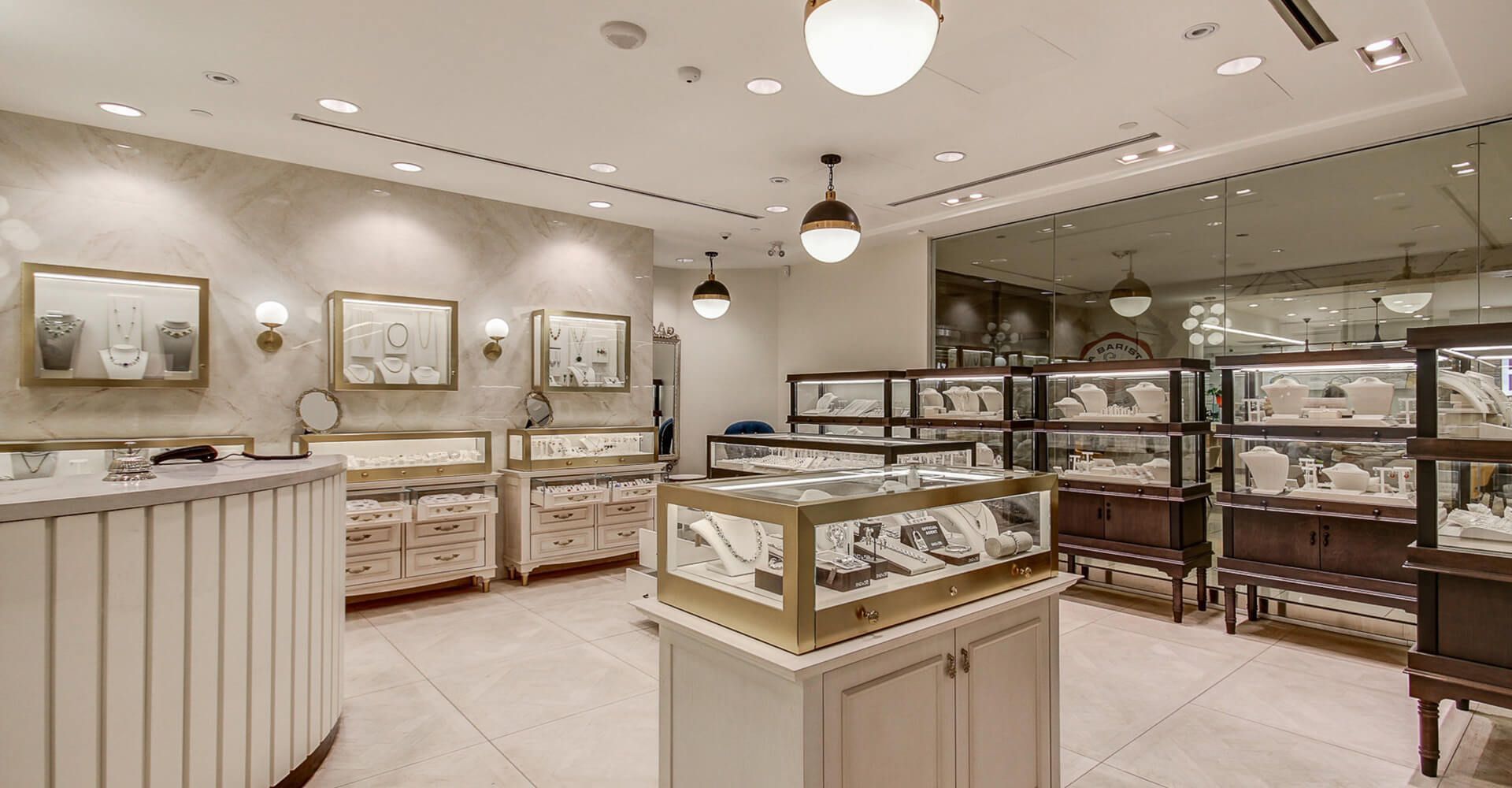 A jewelry store with a lot of display cases and a counter.