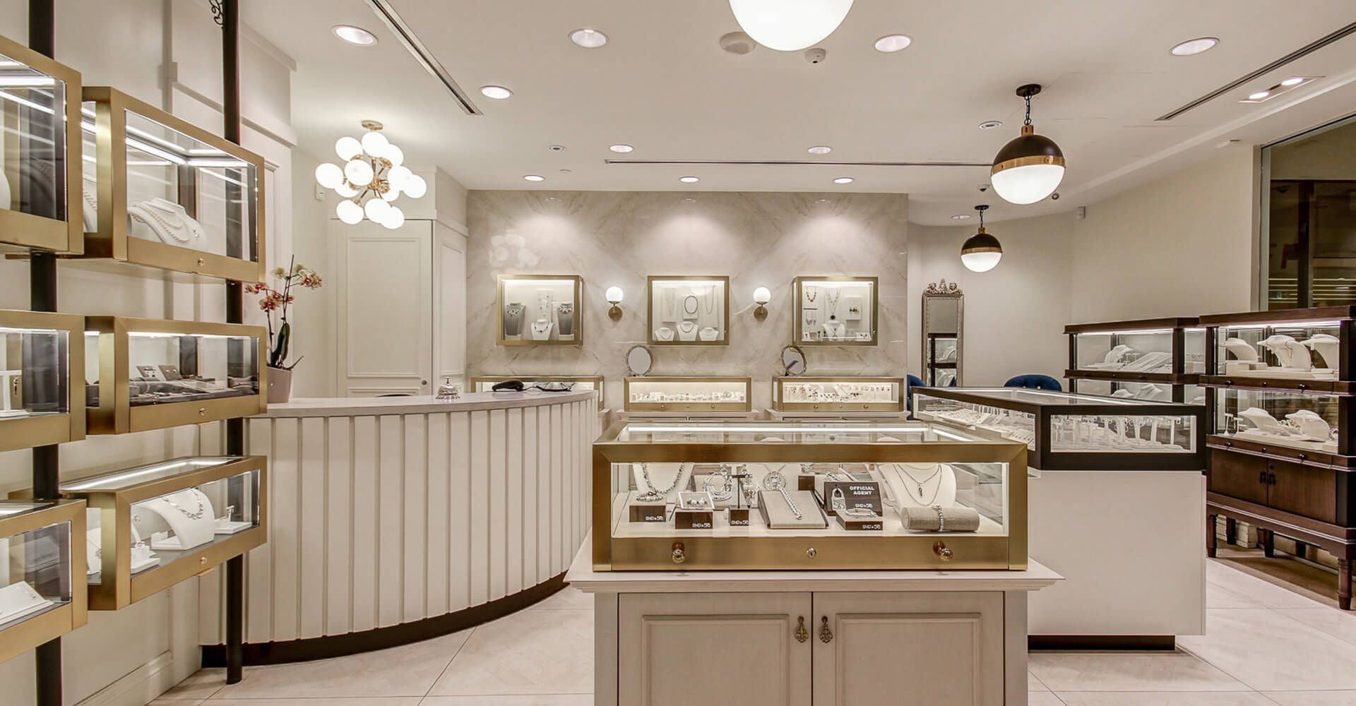 A jewelry store with a counter and display cases filled with jewelry.