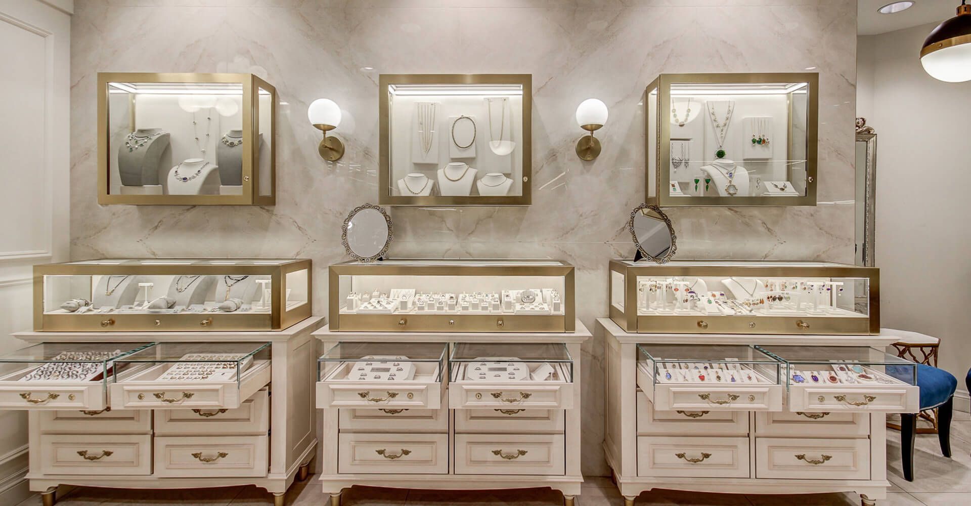 A jewelry store with lots of display cases and drawers.