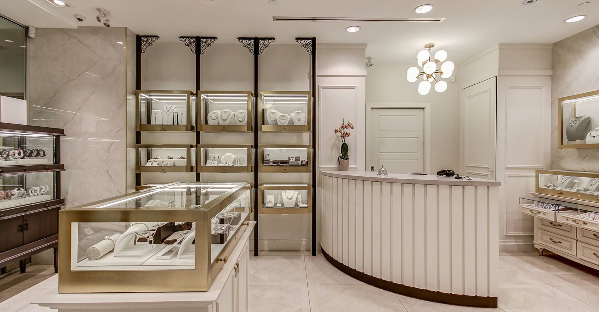 A jewelry store with a counter and display cases filled with jewelry.