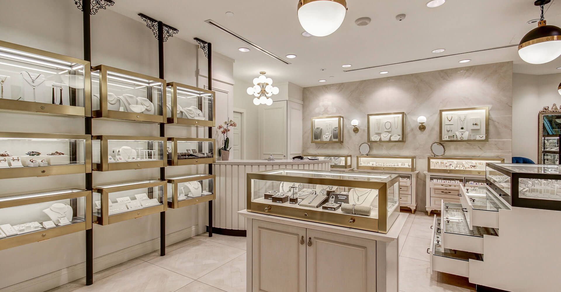 A jewelry store with lots of display cases filled with jewelry.