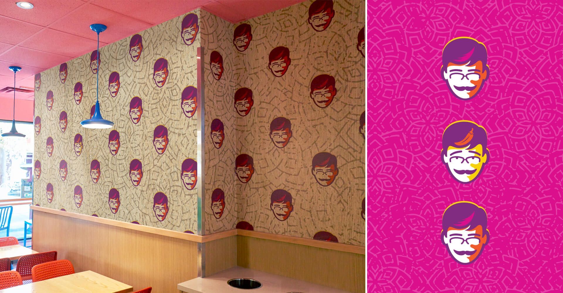 A restaurant with tables and chairs and a wall with a pattern of faces on it.