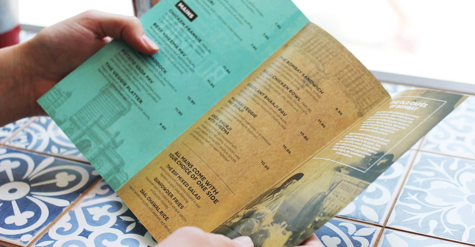 A person is holding a menu in their hands.