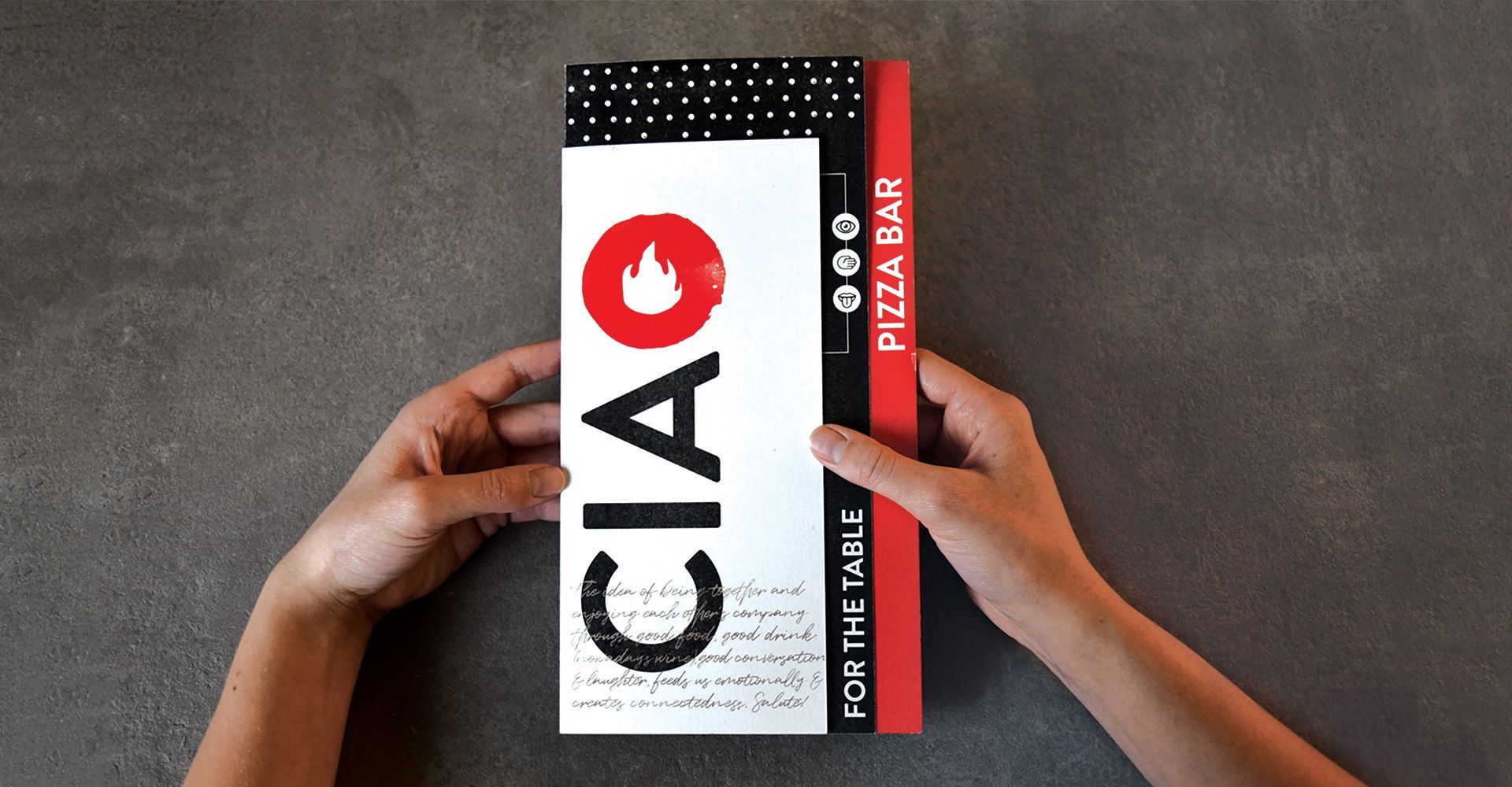 A person is holding a menu for ciao pizza bar