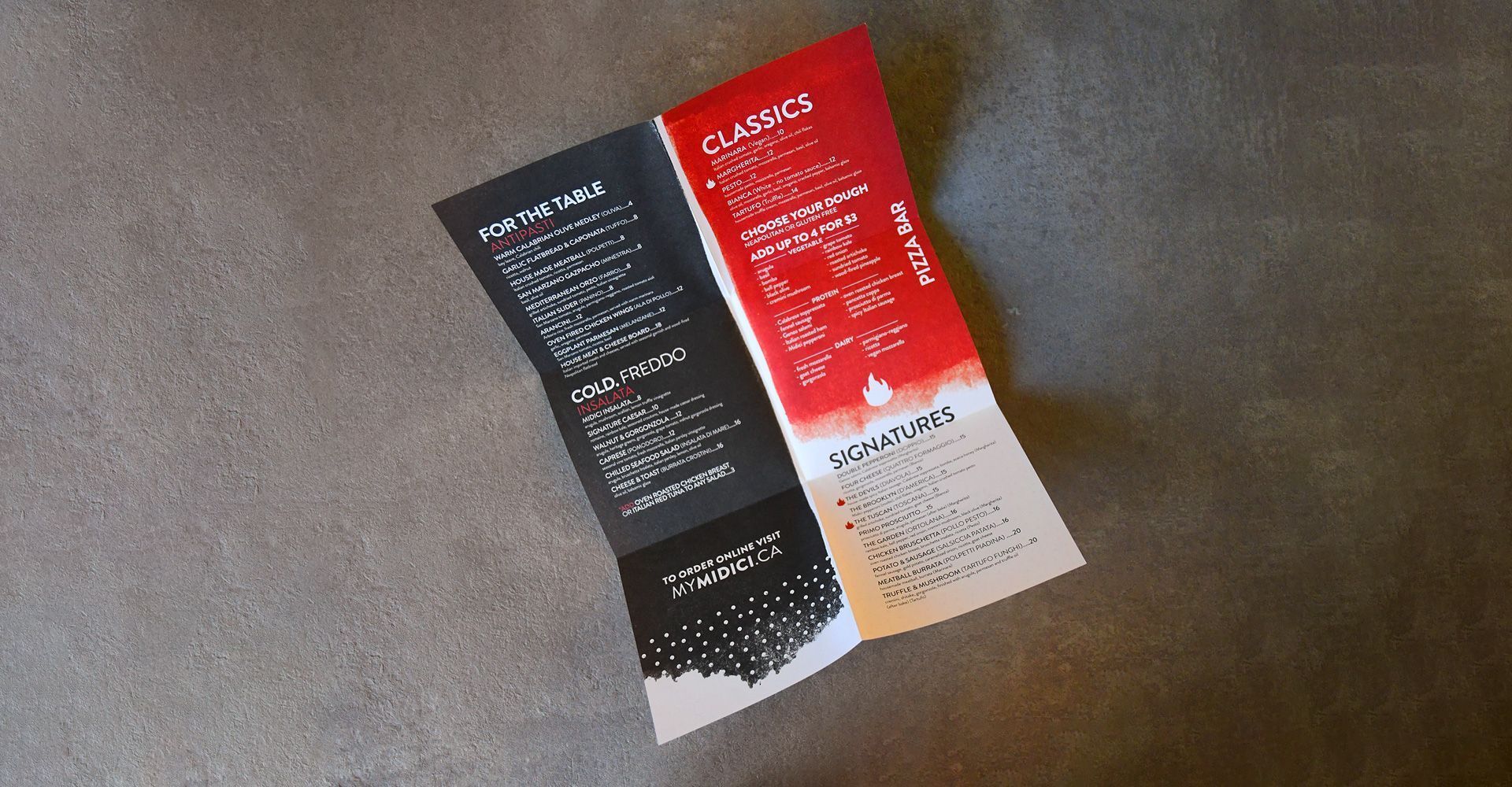 A black and red brochure is sitting on a table.