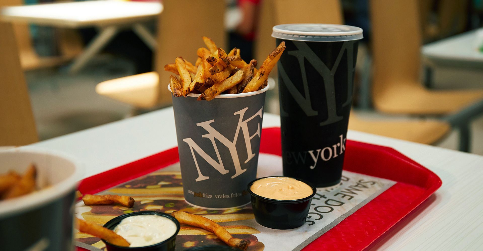 A tray with french fries and a drink on it