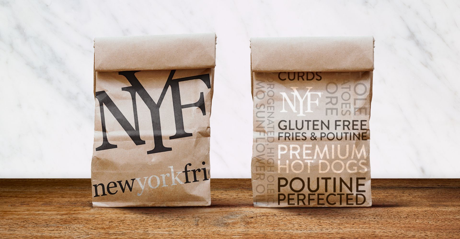 Two bags of new york fri hot dogs on a wooden table