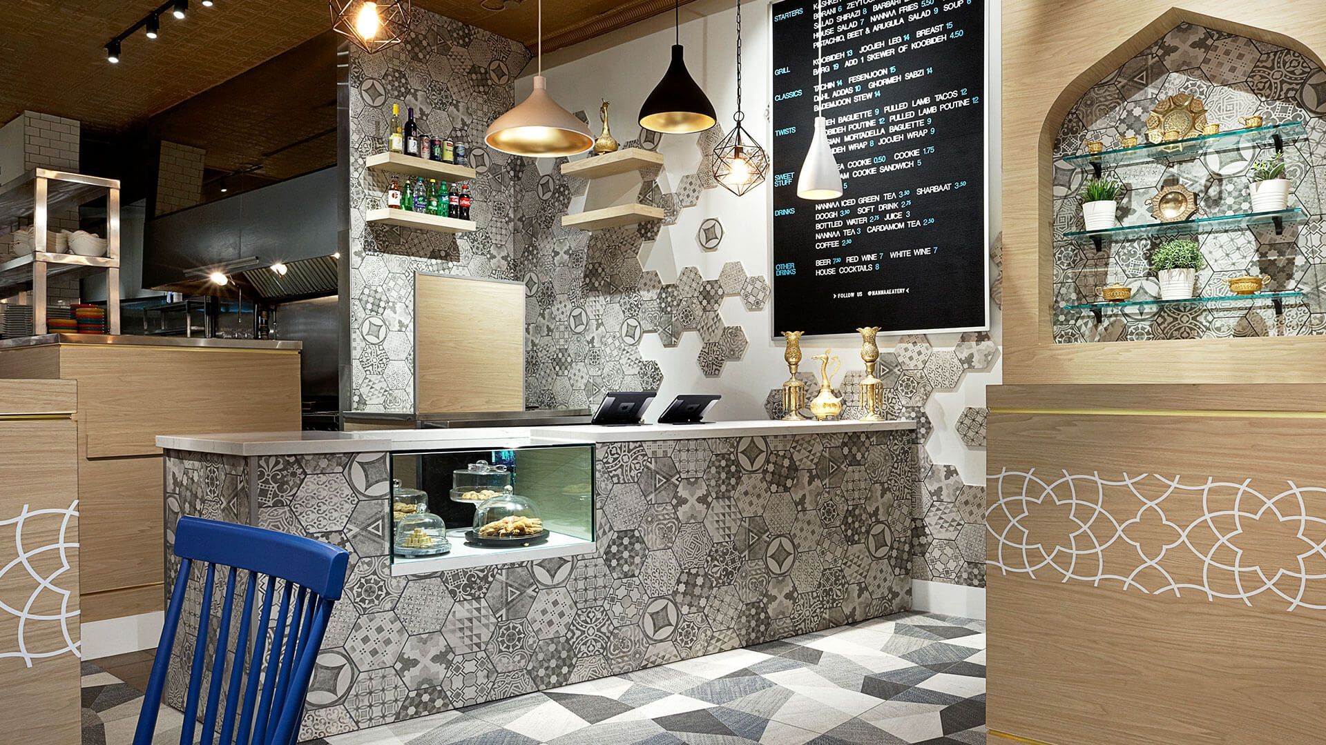 A restaurant with a blue chair and a chalkboard on the wall
