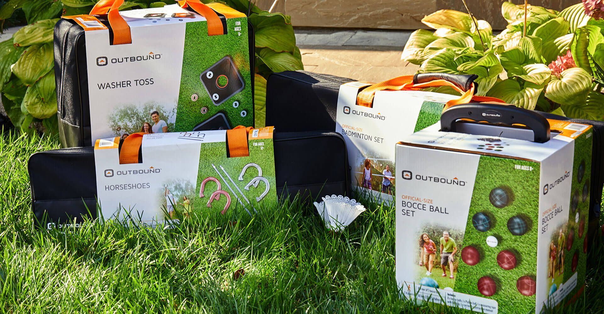 Three boxes are sitting on top of a lush green field