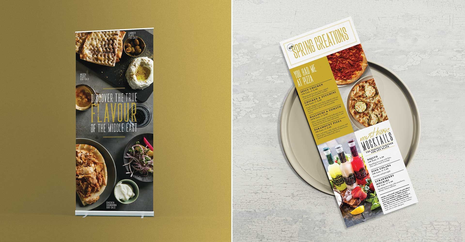 A brochure is sitting on a table next to a plate of food.