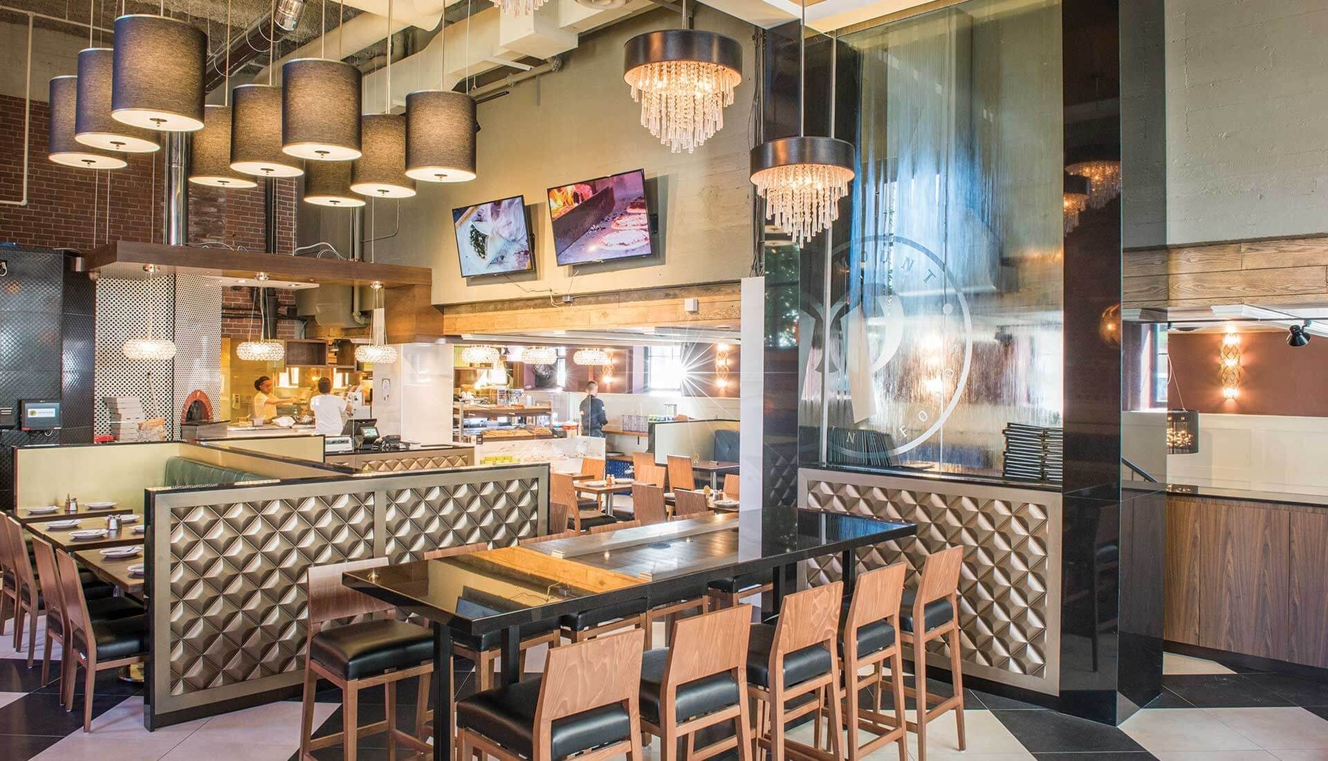 A restaurant with tables and chairs and a chandelier hanging from the ceiling.