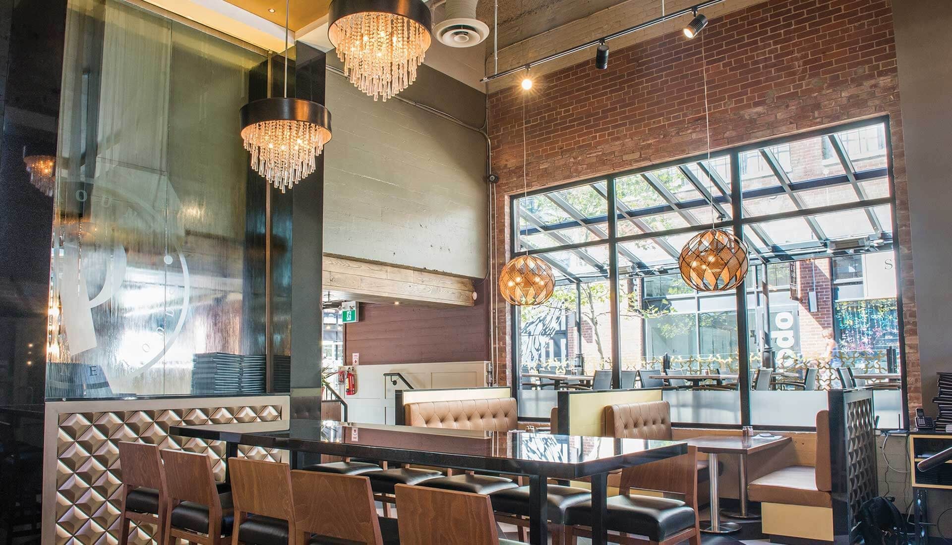 A restaurant with tables and chairs and a large window.
