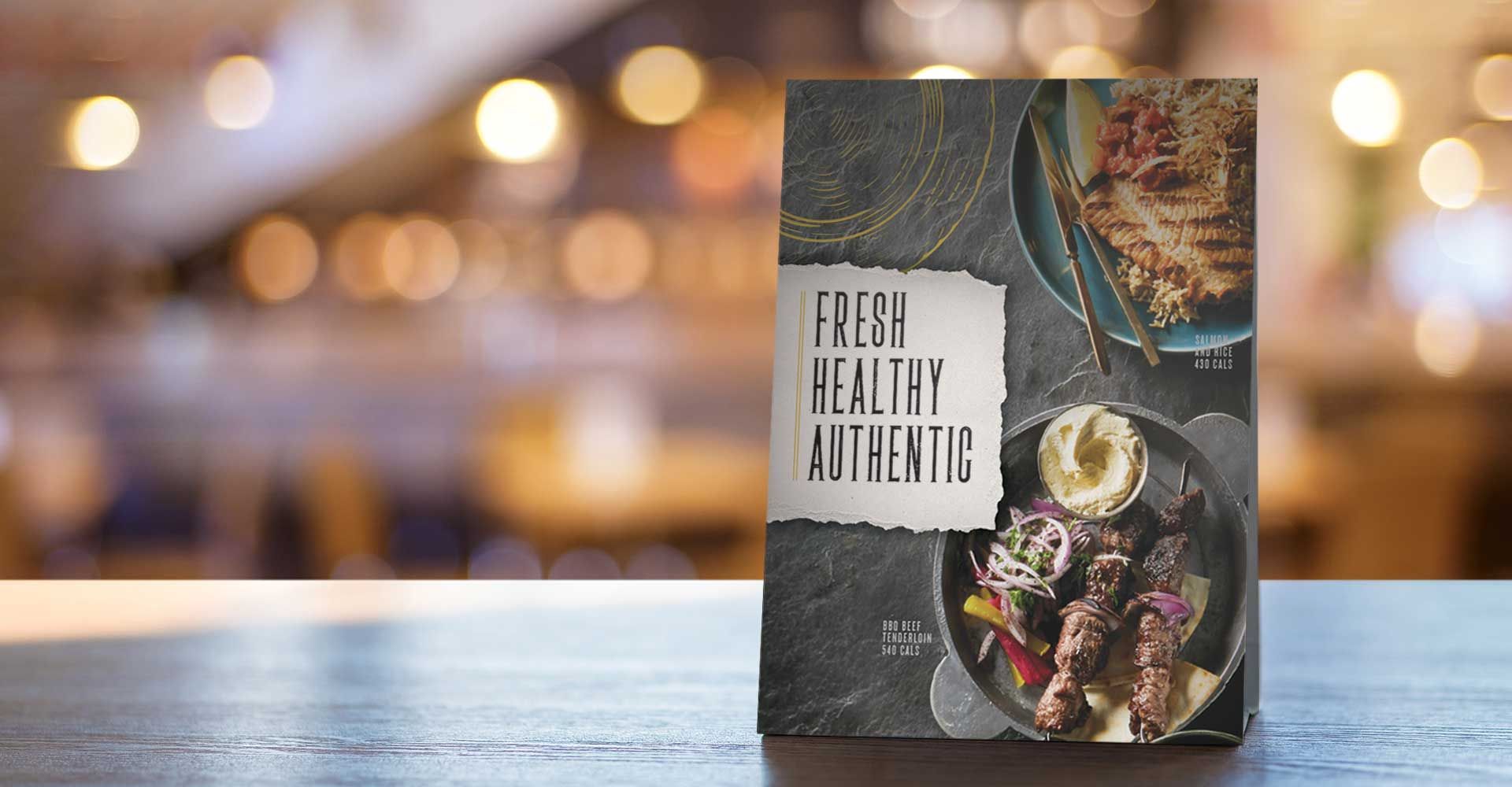 A book titled fresh healthy authentic is sitting on a table.