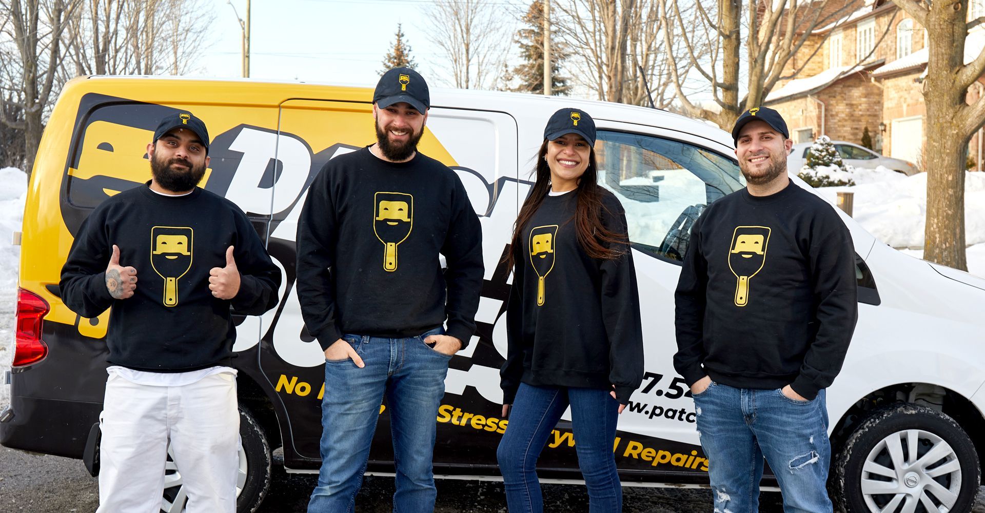 A group of people are standing in front of a van.