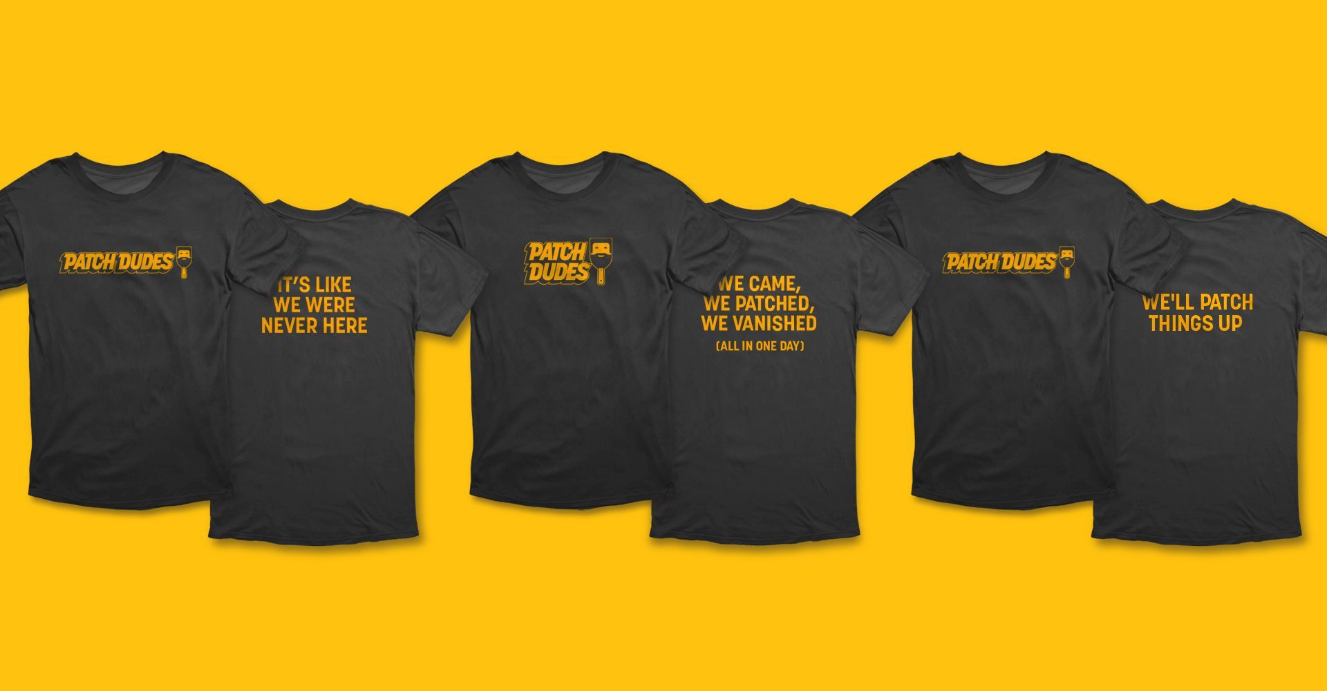 A row of black t-shirts with yellow writing on them on a yellow background.