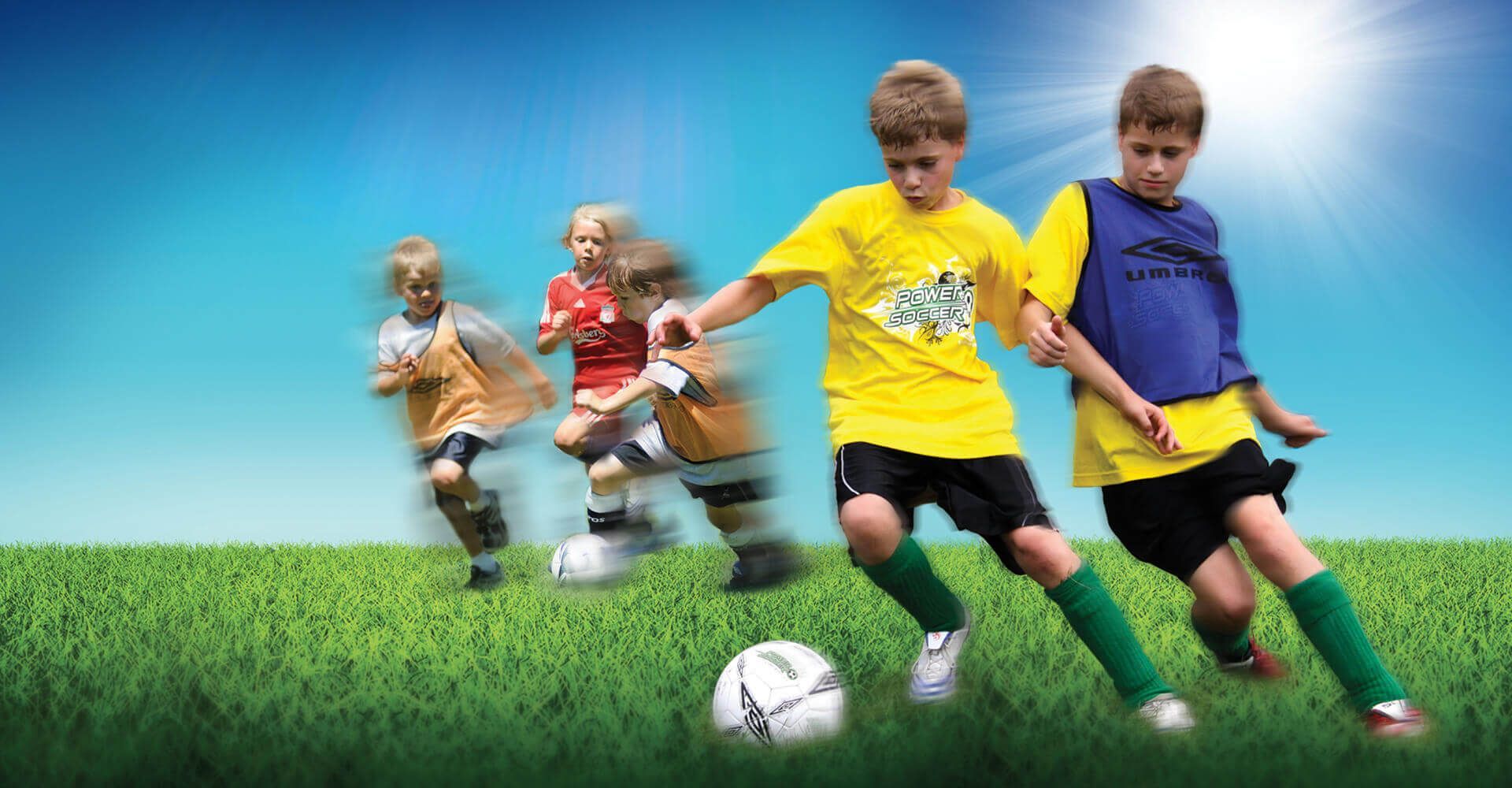 A group of young boys are playing soccer on a field.
