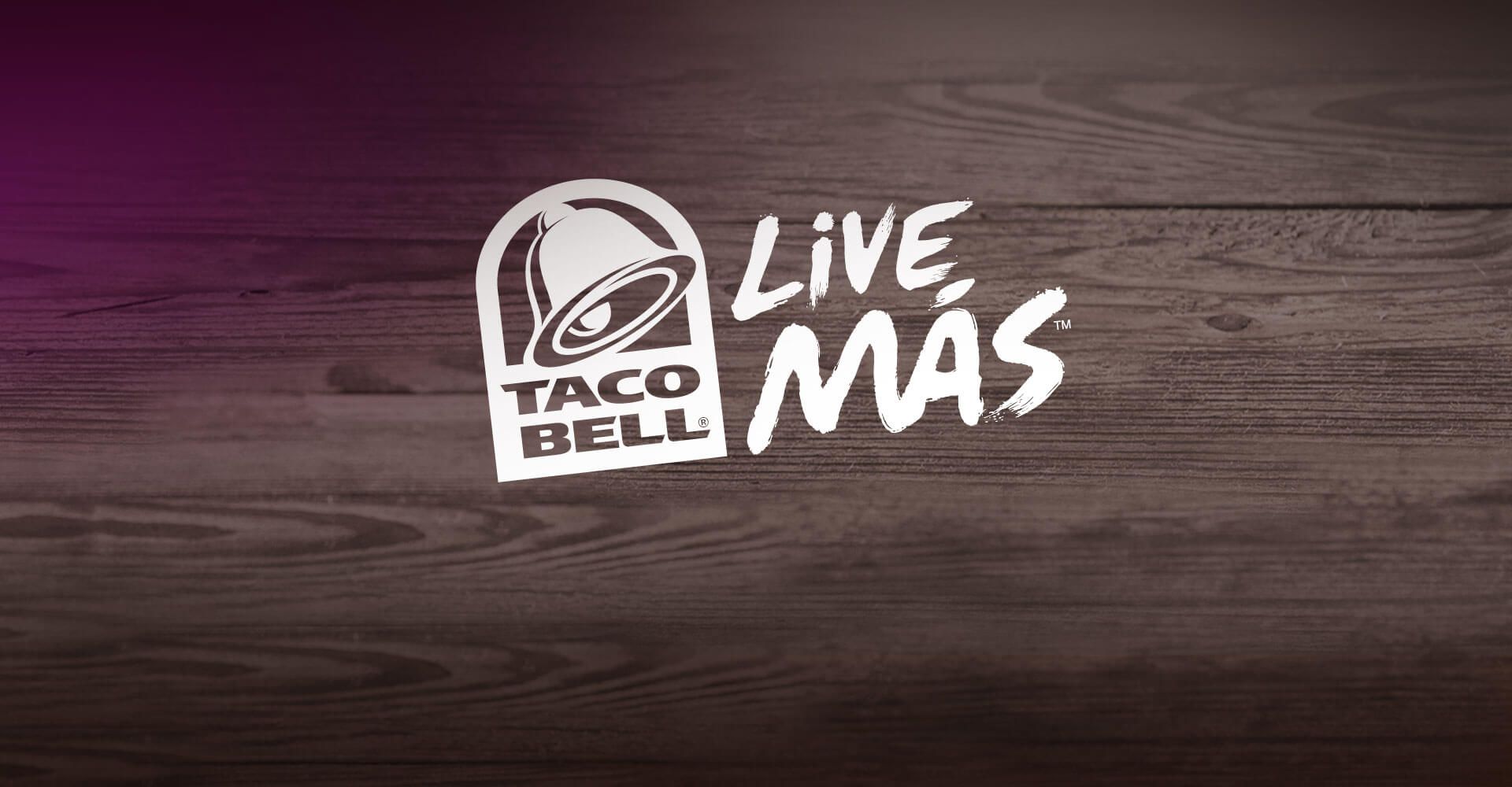 A taco bell logo is on a wooden table.