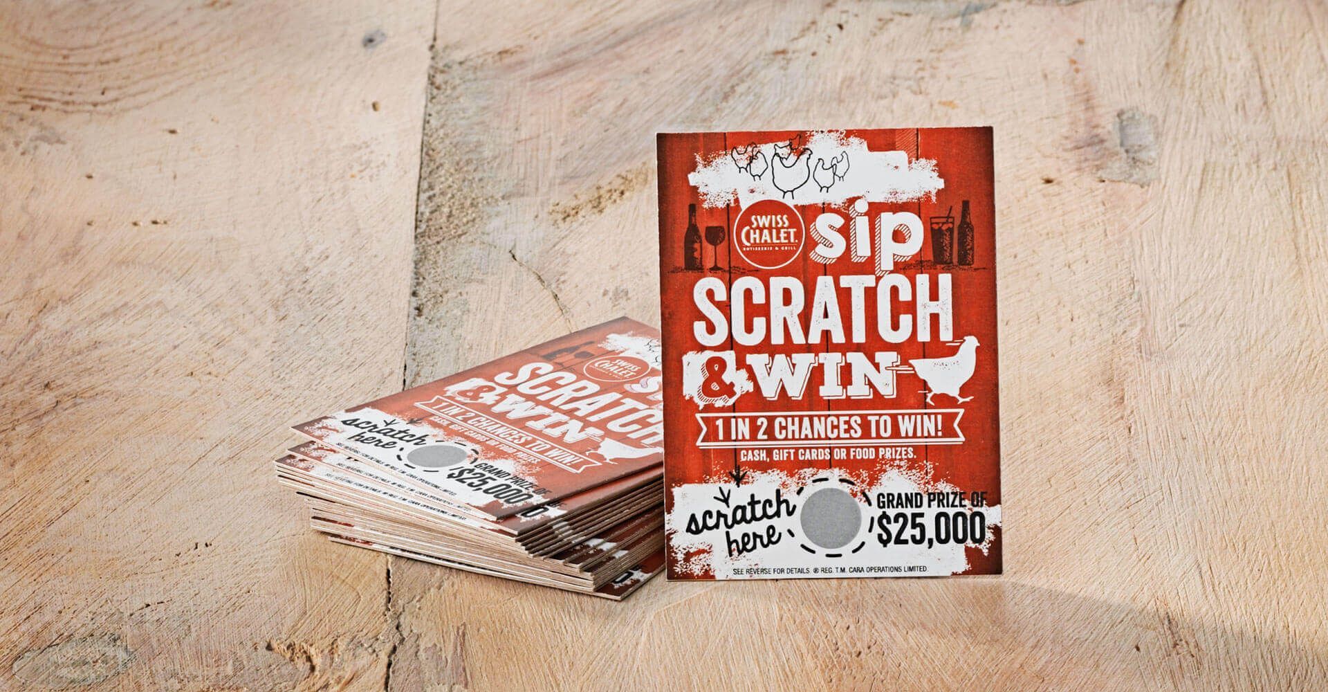 A stack of sip scratch win cards on a table