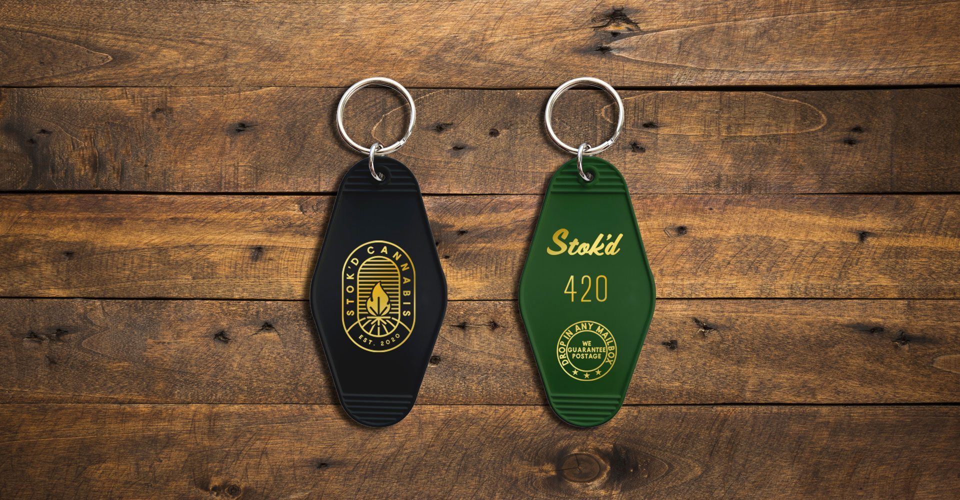 Two keychains are sitting on a wooden table.