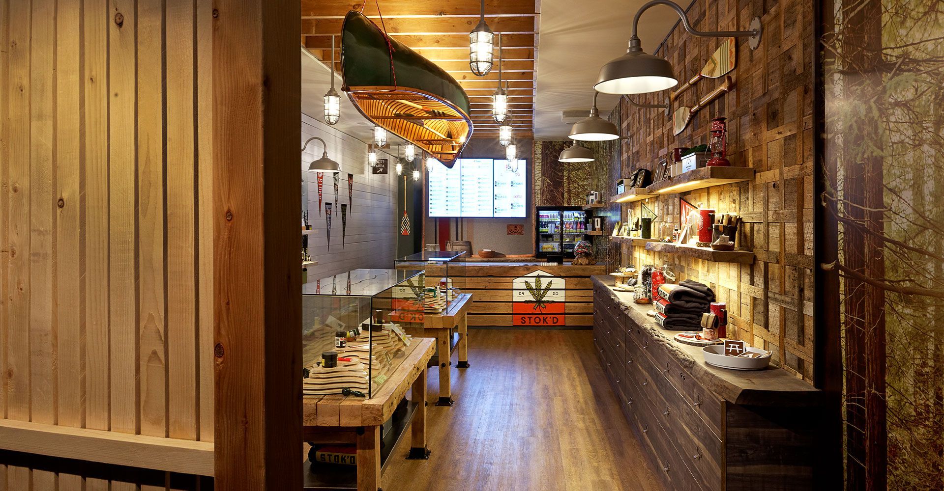 A canoe is hanging from the ceiling of a restaurant.