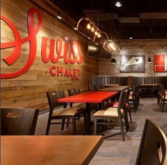 A swiss chalet restaurant with tables and chairs