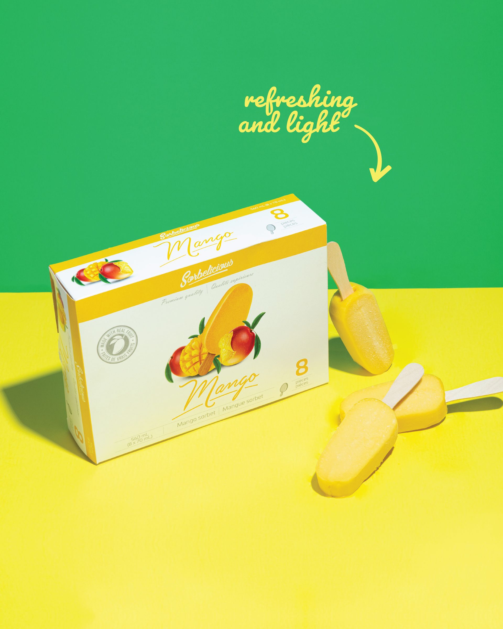 A box of mango ice cream is sitting on a yellow table.