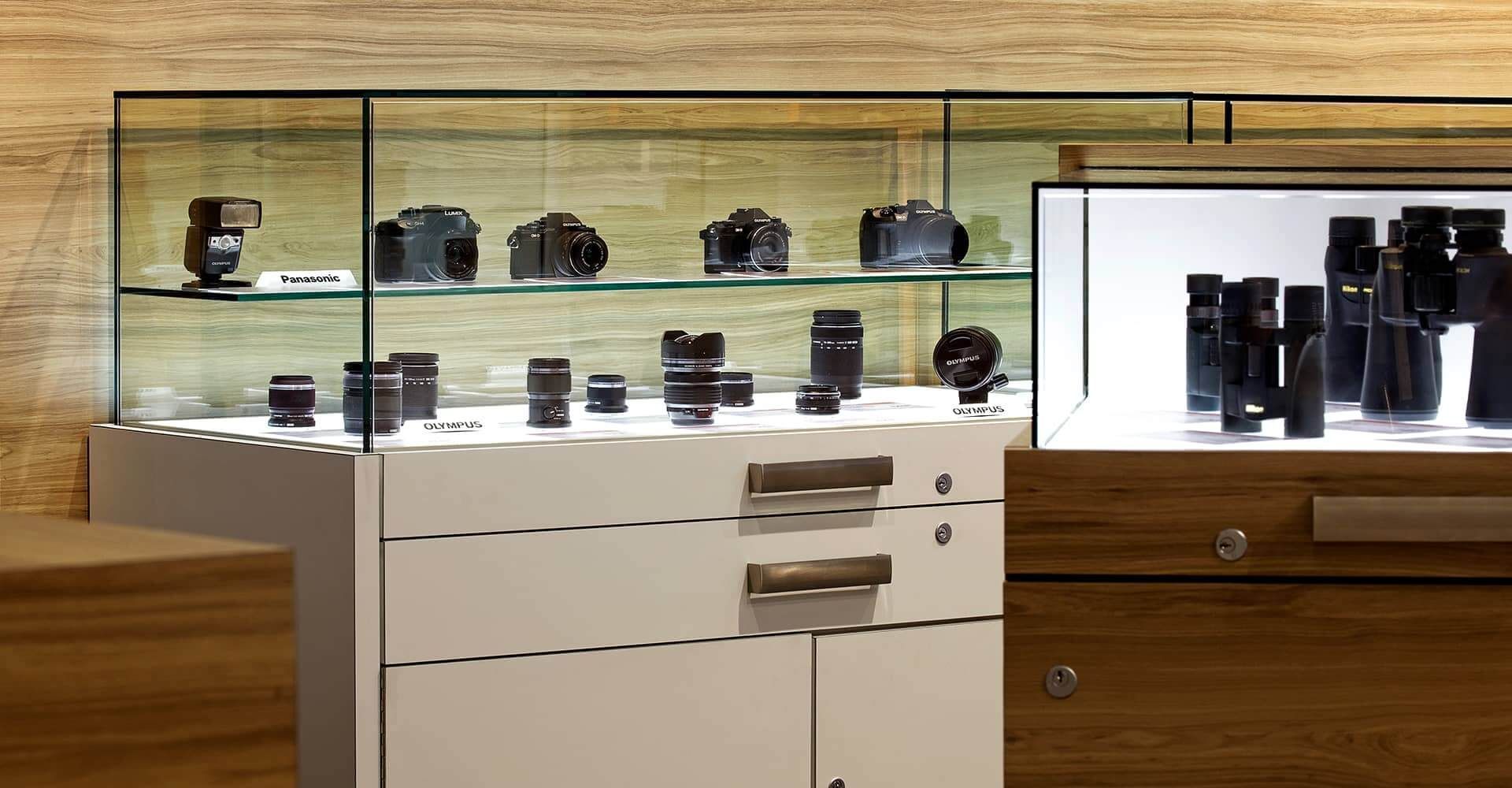 A display case with a lot of camera lenses on it