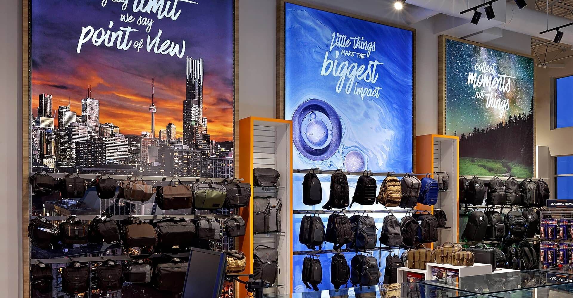 A store with a lot of backpacks hanging on the wall.