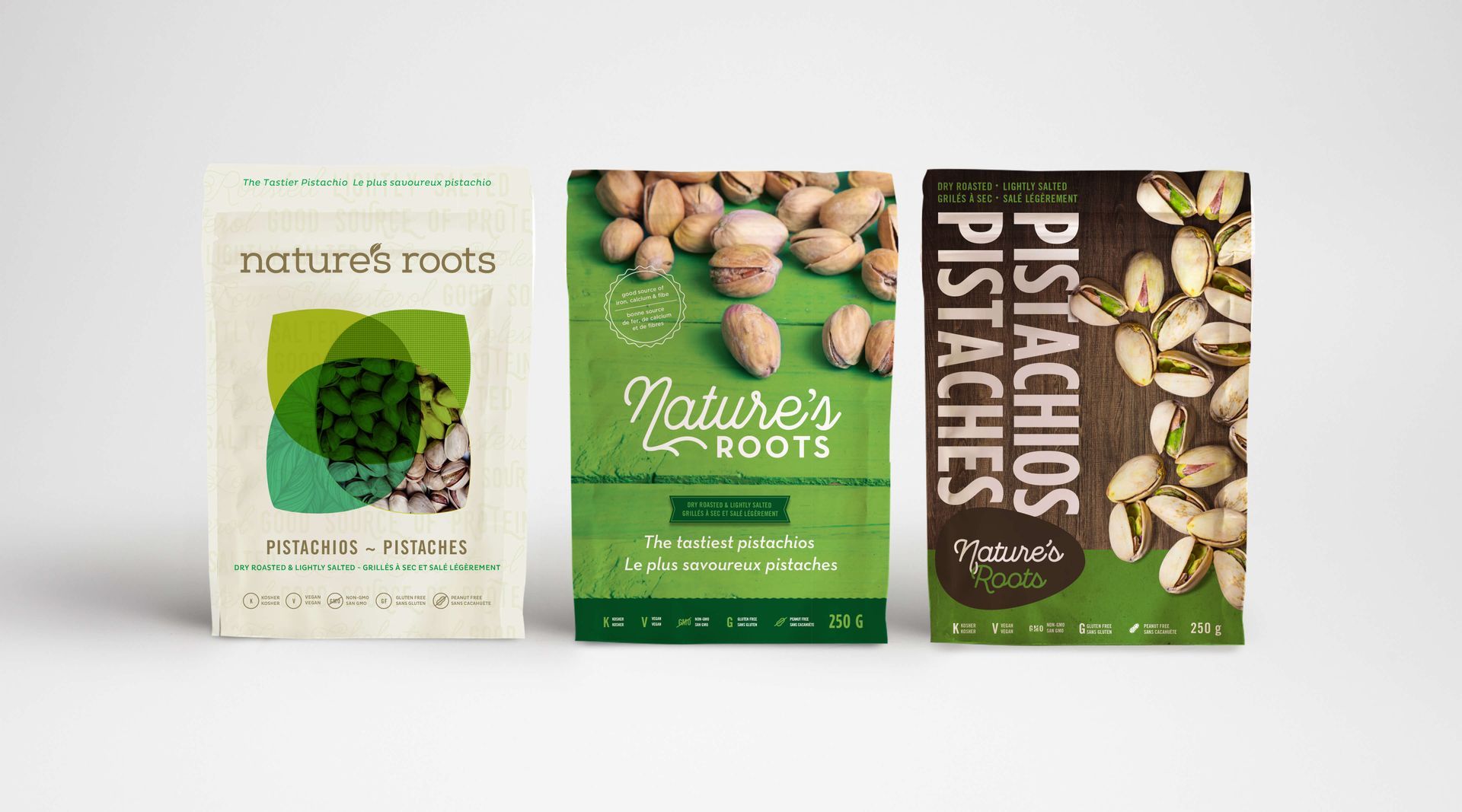 Three boxes of pistachios are sitting next to each other on a table.