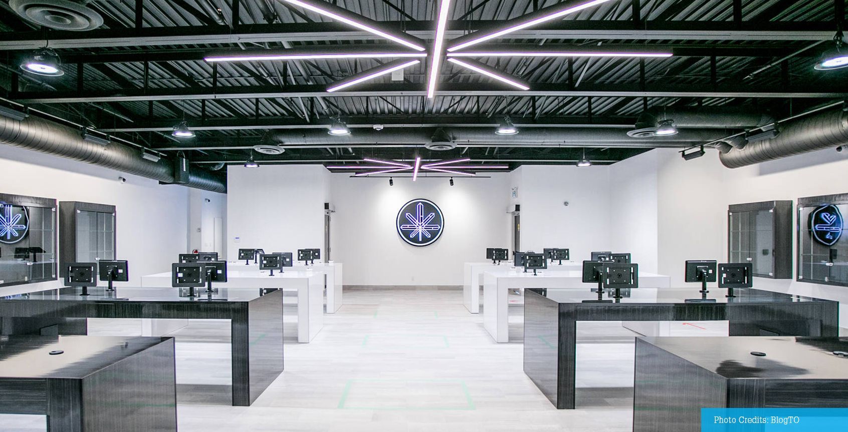 A large room with a lot of tables and computers in it.