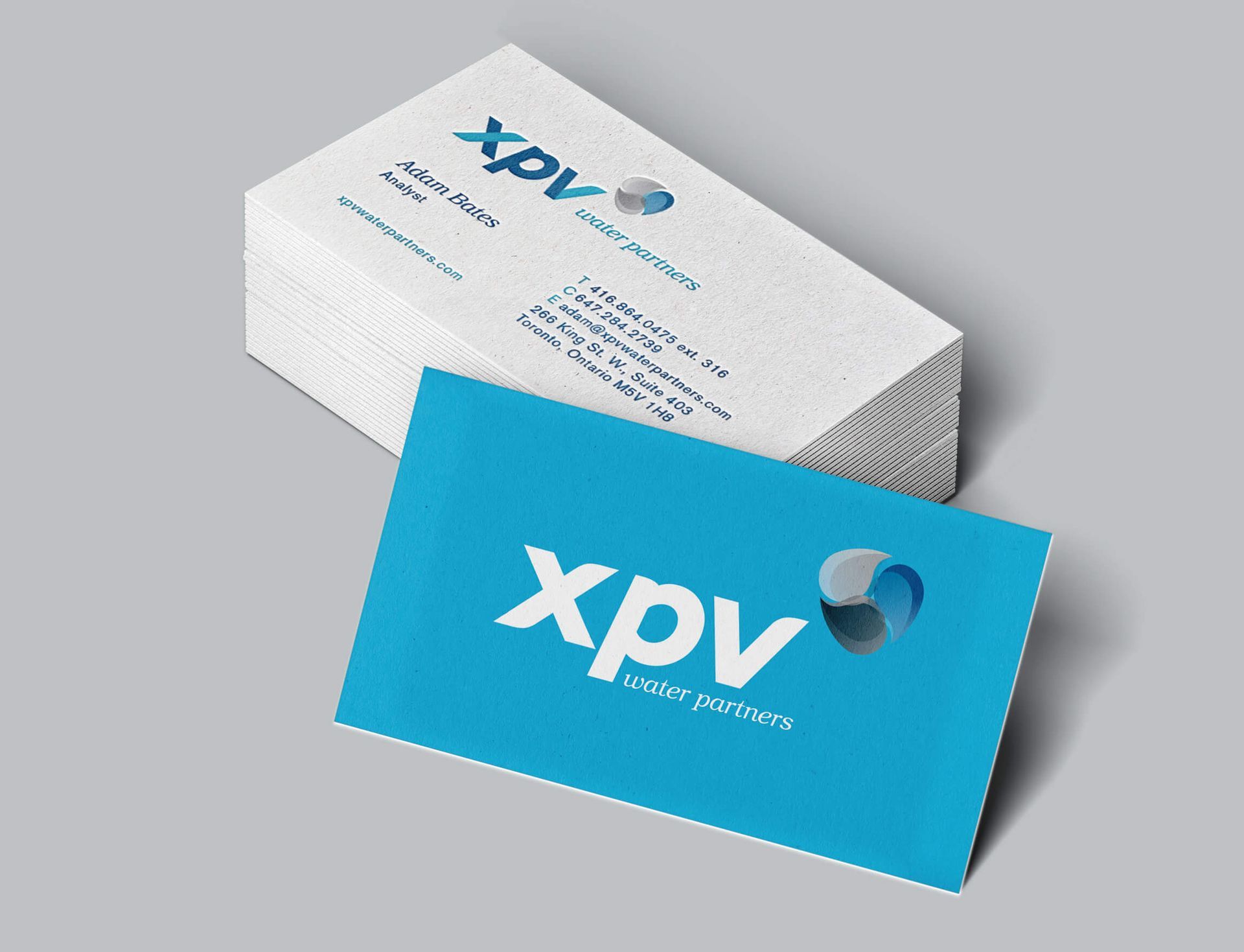 A business card for xpv is stacked on top of each other