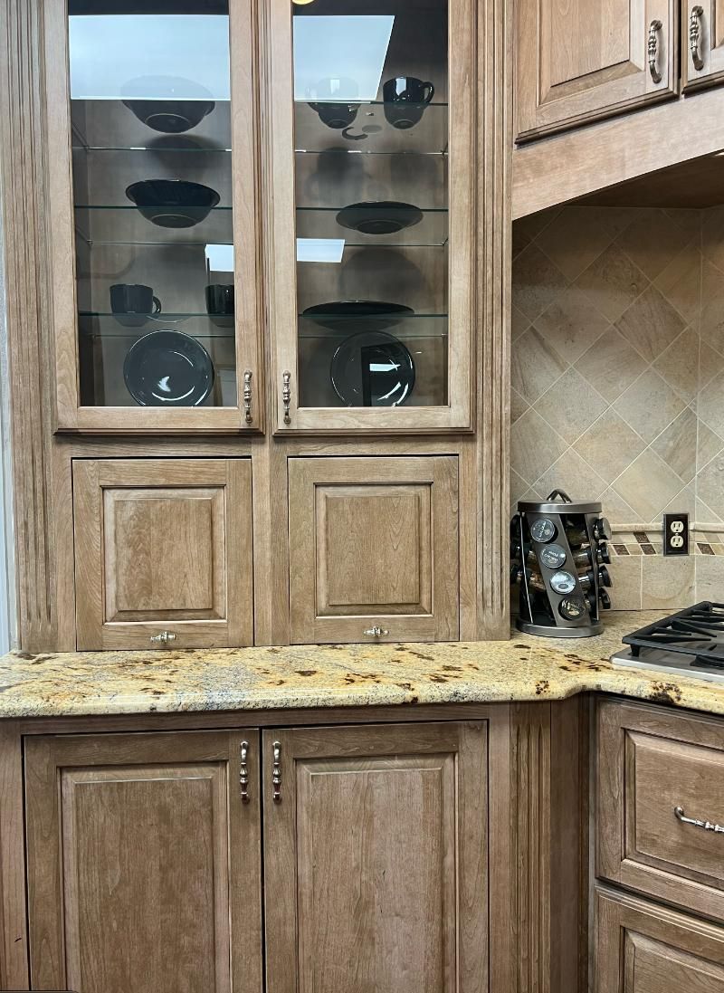 Kitchen cabinets with glass-front display case.