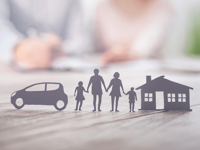 Silhouette of a family standing between a car and a house, symbolizing full coverage from a home and auto insurance broker service in Maricopa, AZ
