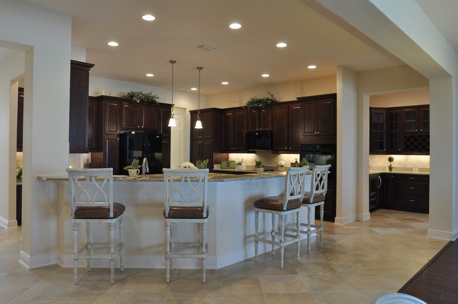 A kitchen with brown cabinets and white counter tops