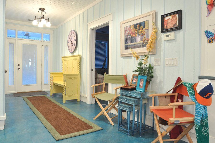 A hallway with a clock on the wall and chairs