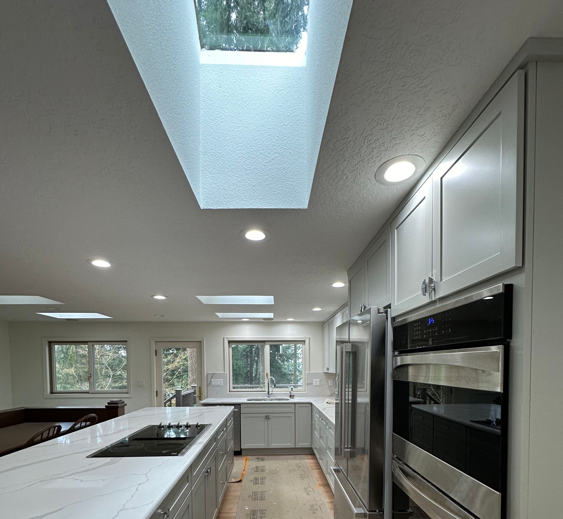 A kitchen with a skylight in the ceiling