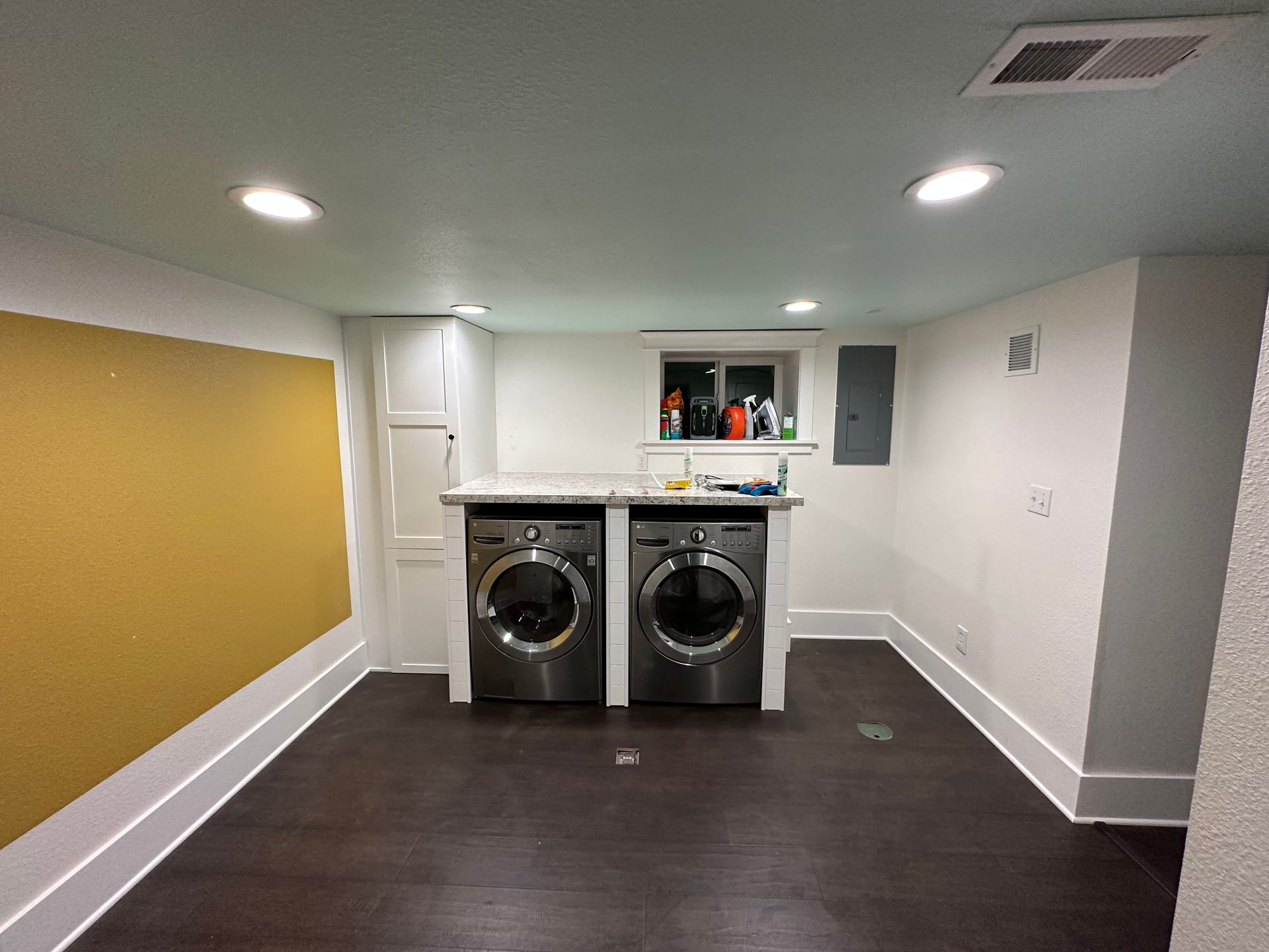 A laundry room with a washer and dryer in it.