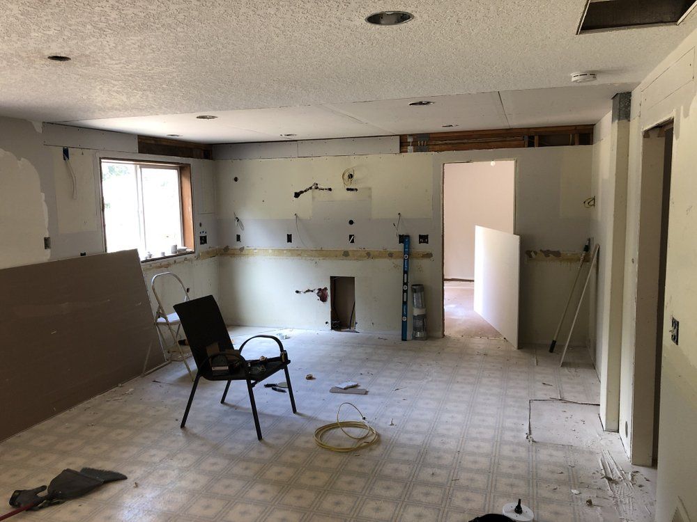 A chair is sitting in a room that is being remodeled.