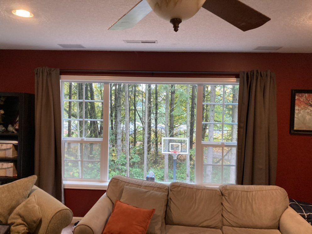 A living room with a couch and a ceiling fan