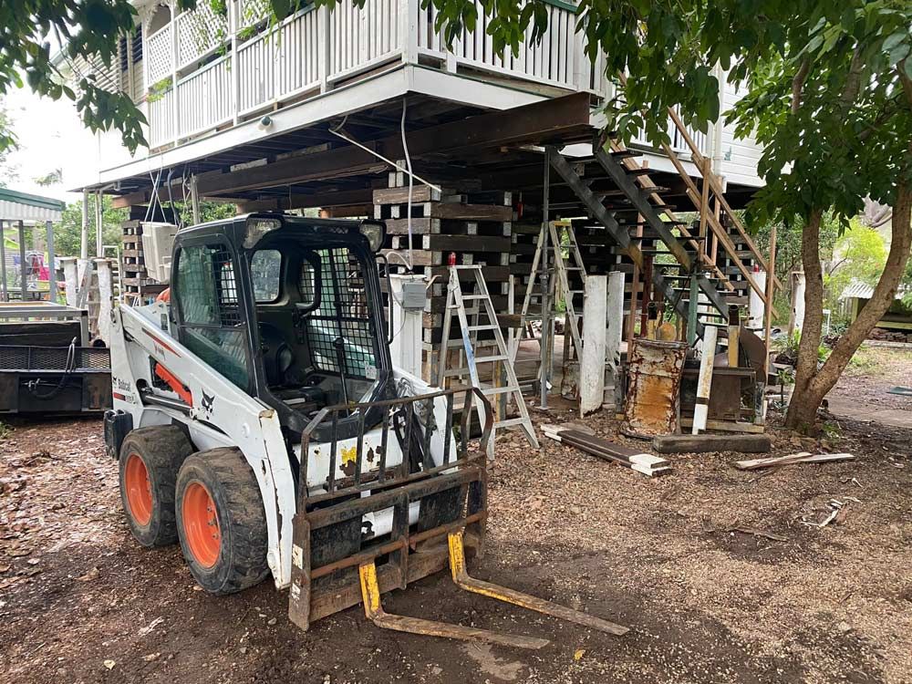 Machinery Beside an Elevated Home — House Lifting Services in Garbutt, QLD