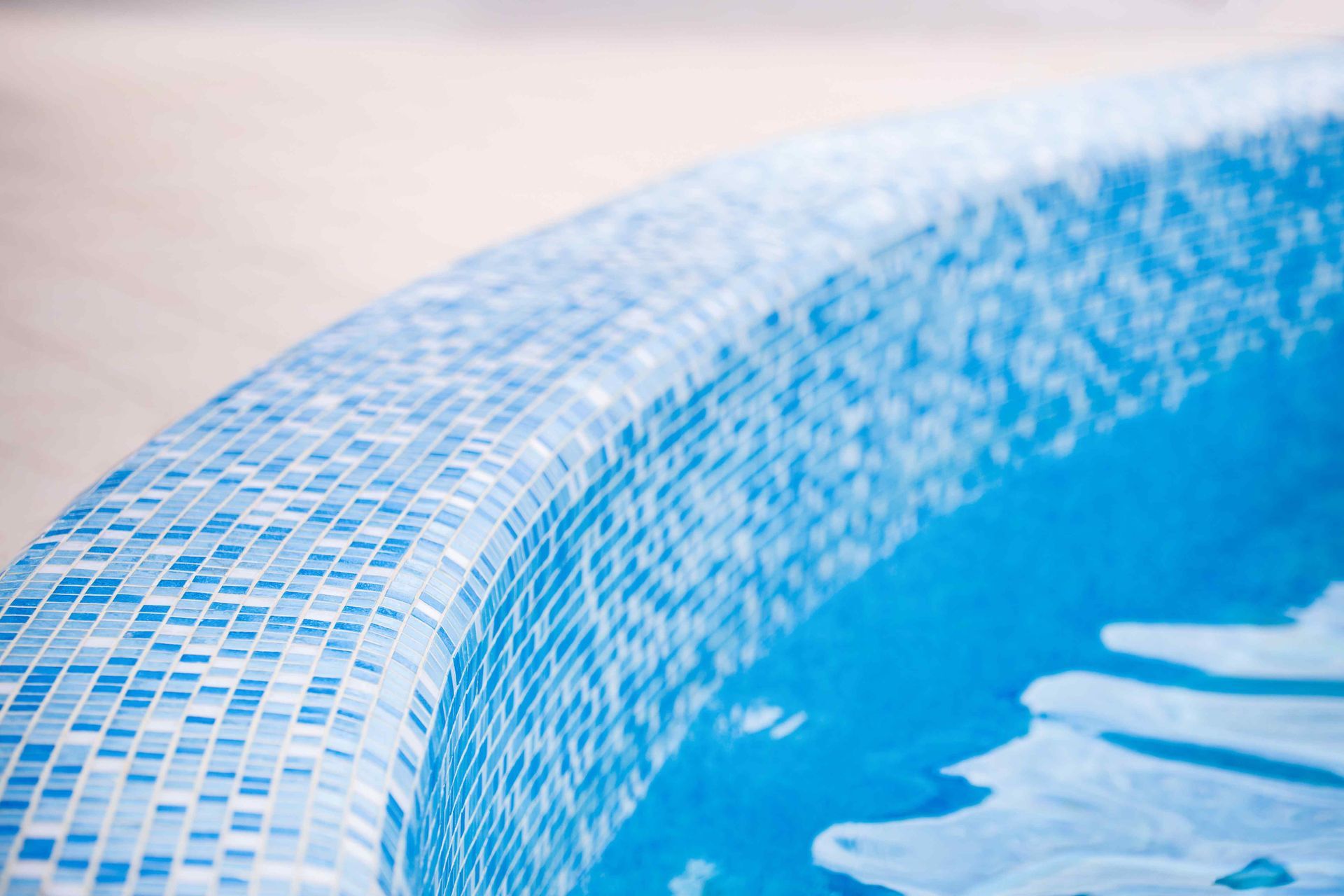 image of the a swimming pools blue rim with the water reflecting