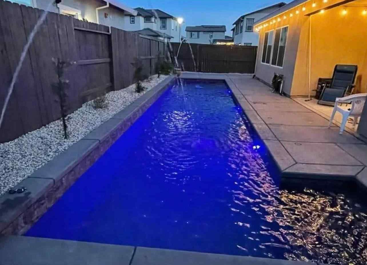 beautiful rectangle pool with vibrant blue water built by prestigious pools
