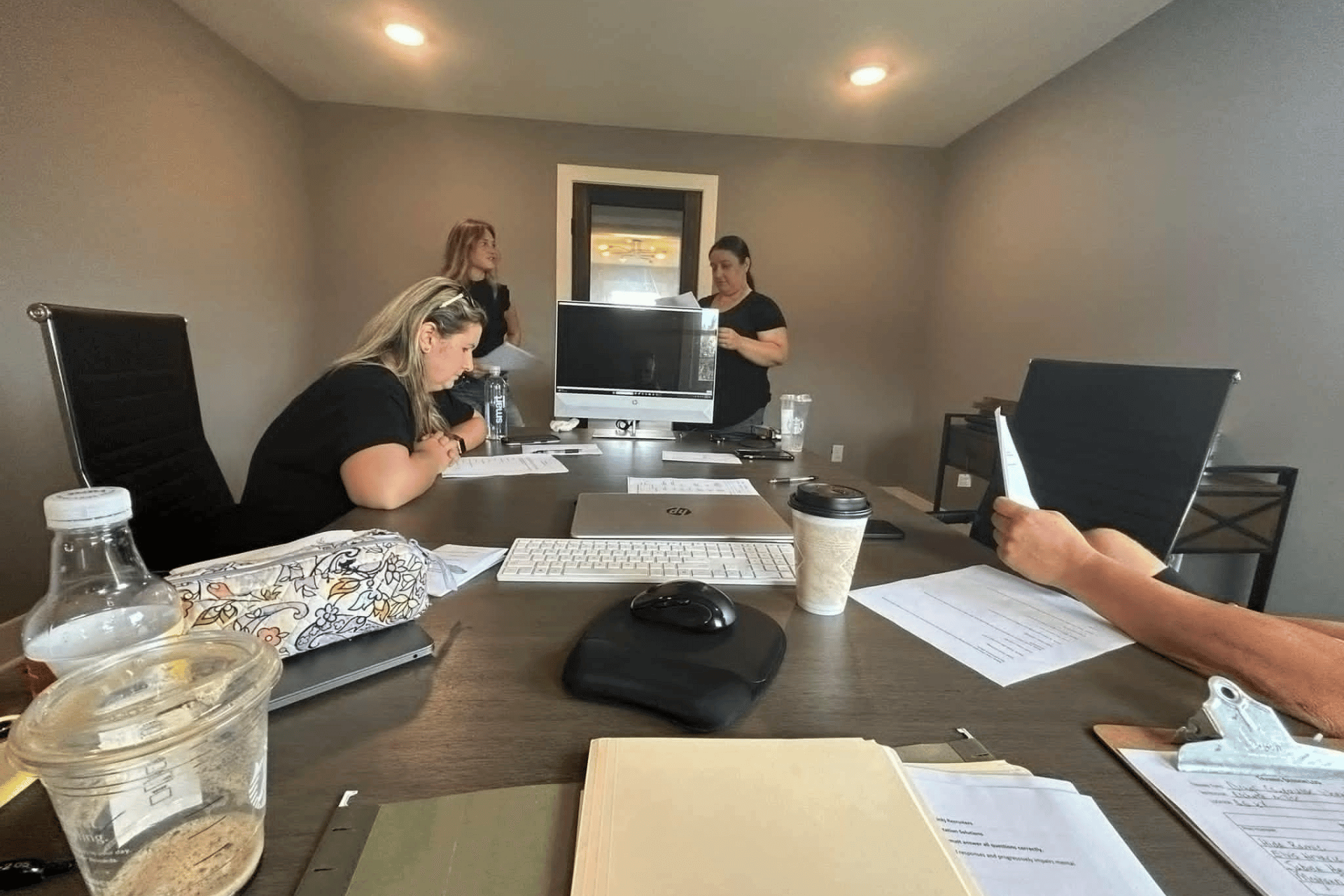 A group of people are sitting around a table in a conference room.