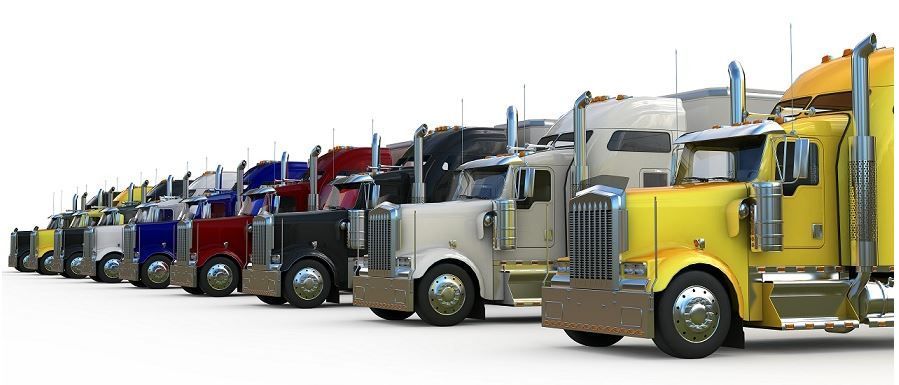 Line of parked semi-trucks showcasing trucking industry fleet
