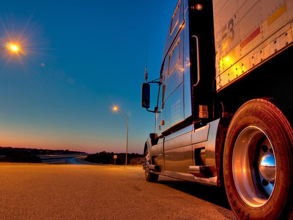 Truck parked in a well-lit lot at night, representing safe and efficient CDL driver recruitment