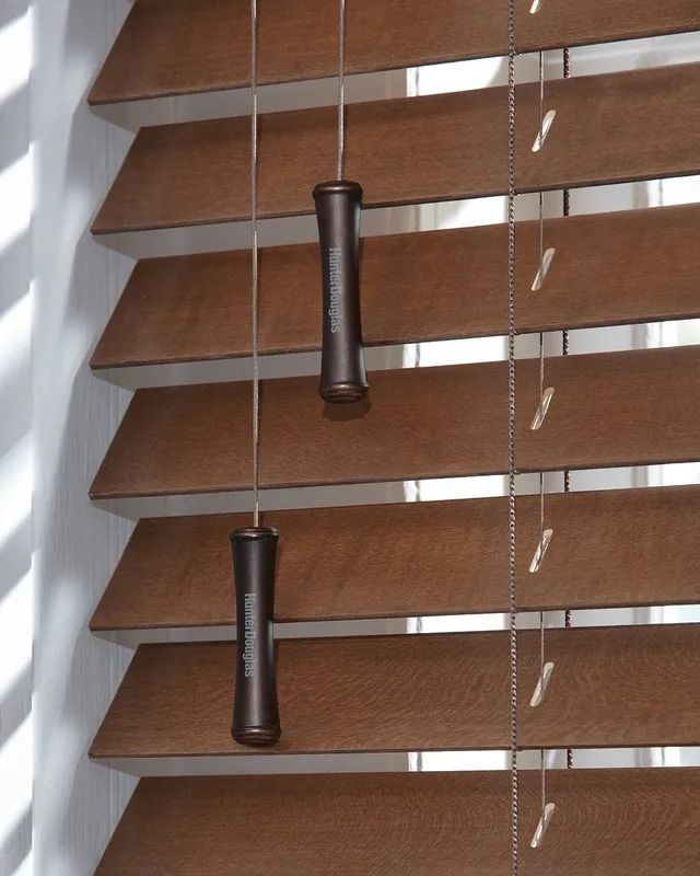 A close up of a pair of wooden blinds