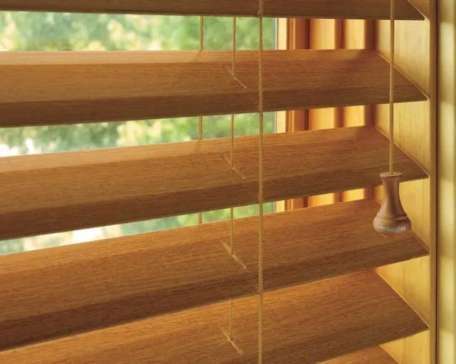 A close up of a wooden blind on a window